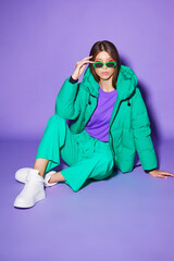 Fashion asian female model in green down jacket and pants.