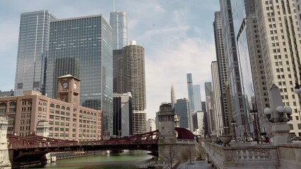 Chicago, Illinois, USA - Mart 21, 2023. People and cars cross the street in downtown Chicago . wide shot 