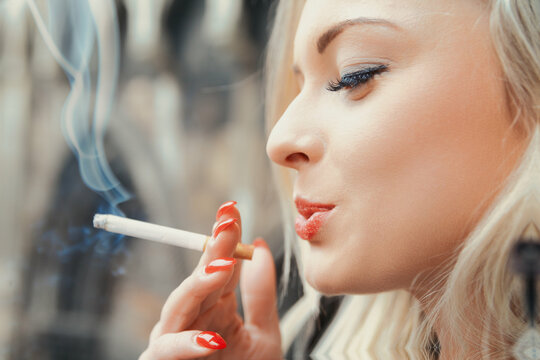 Woman smokes, confusing rebellion with carcinogenic entrapment