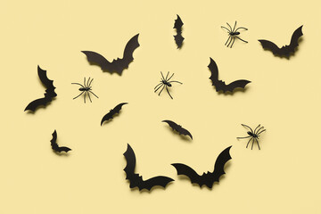 Paper bats and spiders for Halloween party on yellow background