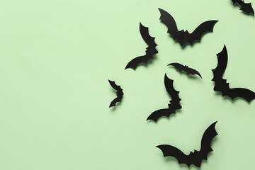 Paper bats for Halloween party on green background