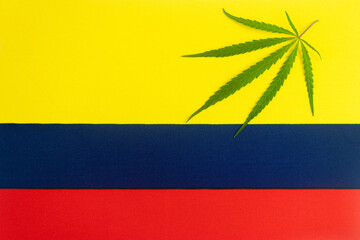 hemp leaf on background of the colombian flag. Concept of legalization and changes in legislation...