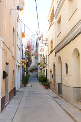 Fototapeta na wymiar Narrow streets in the old quarter of the Mediterranean town of Blanes in the province of Barcelona, Catalonia, Spain.