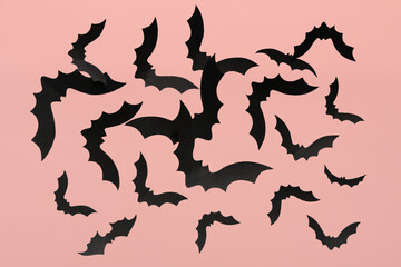 Paper bats for Halloween party on pink background