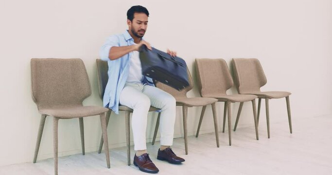 Problem, search and lost in a bag with a man in office row for hiring with stress and anxiety. Finding, forget and laptop briefcase looking for resume, wallet or keys for interview at waiting room