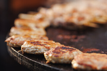 Cook grills chicken kebab steaks open fire. Concept Summer Street food festival