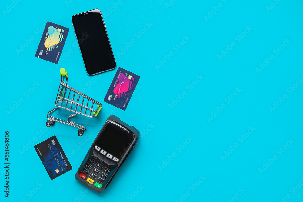 Sticker Shopping cart with payment terminal, mobile phone and credit cards on blue background