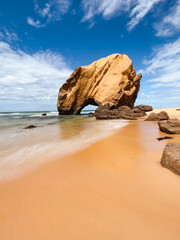 Stone rock at ocean side beach in a summer day. Santa Cruz beach, Torres Vedras, Portugal - 651452815