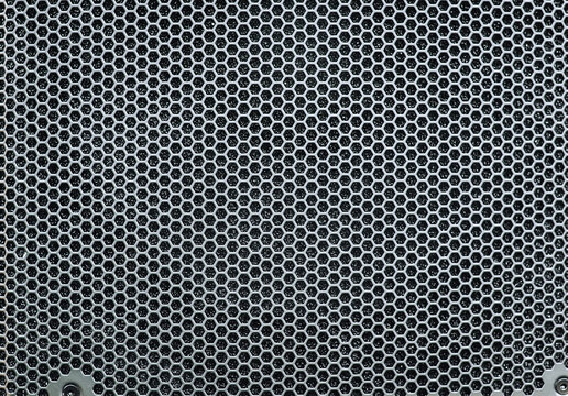 Background, texture of a musical speaker made of metal lattice. Close-up photo.