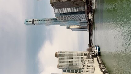 Chicago, Illinois, USA - Mart 21, 2023. People and cars cross the street in downtown Chicago . vertical shot in day time