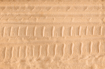 Trace, imprint, pattern of car tires, wheels on sand, road, soil. Photography, background, texture,...