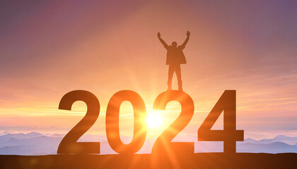 2024. New Year 2024. Man standing at top of data 2024 as sun begins to set. Success Business Leadership. Goals, hopes and aspirations concept. Male silhouette on sunrise background