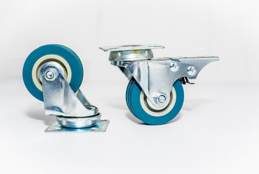 pair of furniture steel roller castors one with brake isolated on a white background 2 inch