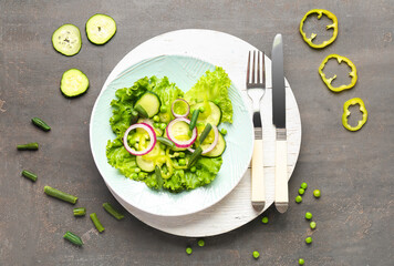 Bowl of tasty vegetable salad on grey background