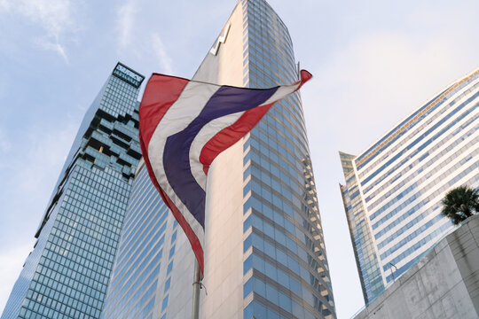 Dynamic fluttering Thailand flag in front of King Power Mahanakhon skyscraper, Bangkok, Thailand