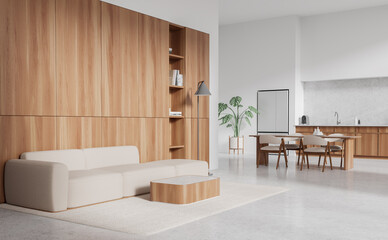 White studio interior with couch and dining corner, cooking space with fridge
