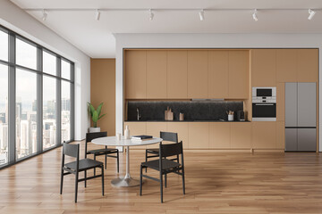 Beige hotel kitchen interior with dining and cooking space, panoramic window