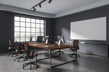 Grey coworking interior with pc monitors on table, window. Mock up whiteboard