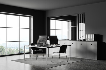 Grey office interior with pc monitors and sideboard with folders and window
