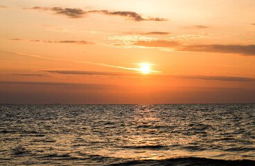 Sunset on the Baltic Sea in Poland. Landscape in the evening with setting sun by the sea.