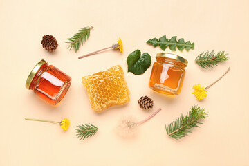 Jars with tasty honey, honeycomb, dandelion flowers and fir tree branches on beige background