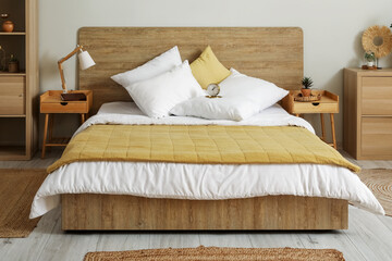Fototapeta na wymiar Interior of stylish bedroom with alarm clock on bed