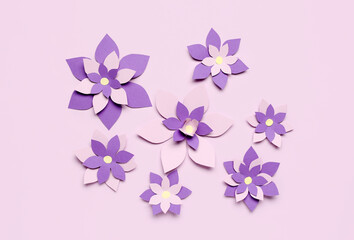 Colorful origami flowers on purple background