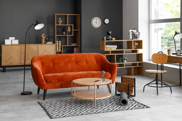 Interior of modern living room with sofa, table and fitness mat