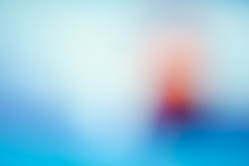 Red and light spots on a blue abstract blurry gradient background.
