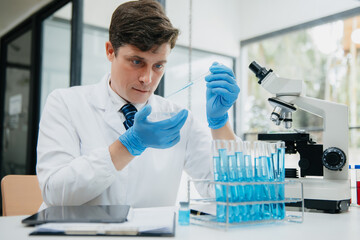 Male scientist researcher conducting an experiment in a laboratory.