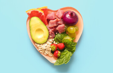 Plate with fresh healthy products on blue background. Diet concept