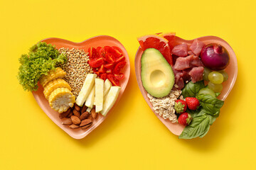 Plates with fresh healthy products on yellow background. Diet concept