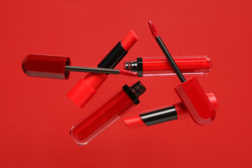 Lipsticks flying on red background