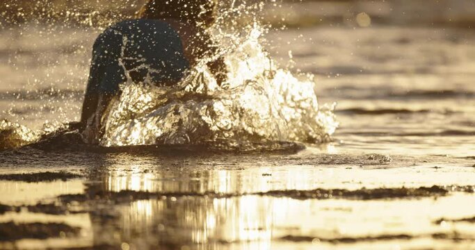Feet running on the sand on beach. Happy child stumbles over an invisible obstacle in gets up and runs on as if nothing had happened. Resilience in overcoming difficulties. Falling is normal