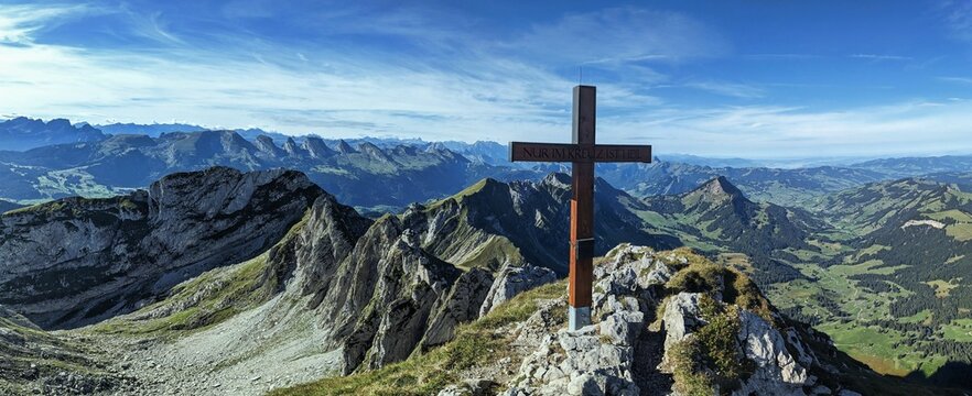 Panorama picture on the Silberplatten with summit cross in Appenzell. With a view of the Churfirsten in Toggenburg. High quality photo