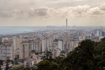 Beautiful panorama of the bay of Algiers, Alger, Algeria, with the industrial port and the Djamaa El-Djazaïr (English : Great Mosque) in the background. Cloudy sky.