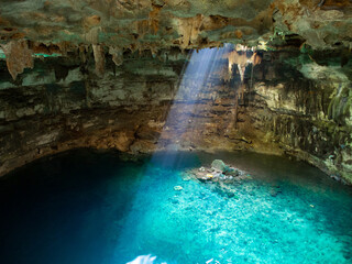 Cenote in Mexico with crystal clear, blue water (cave)