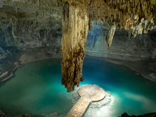 Cenote in Mexico with crystal clear, blue water (cave)