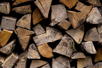 Dry firewood, wooden logs stacked on top of each other. Firewood, background. Dry chopped firewood, ready for winter