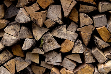 Dry firewood, wooden logs stacked on top of each other. Firewood, background. Dry chopped firewood, ready for winter