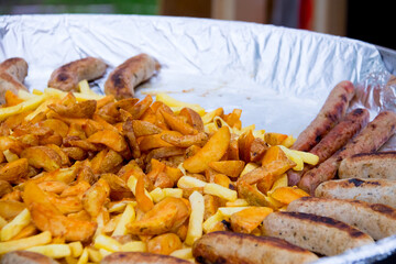 grilled fried delicious potatoes and baked sausage