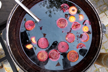 A saucepan with hot mulled wine and fruit
