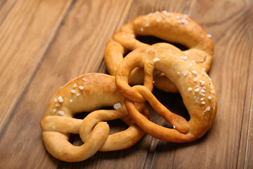 Soft pretzels on wooden background