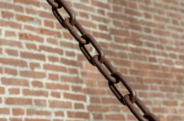 rusty chains, brick background, a symbol of strength and oppression, used in industry in crowbars...