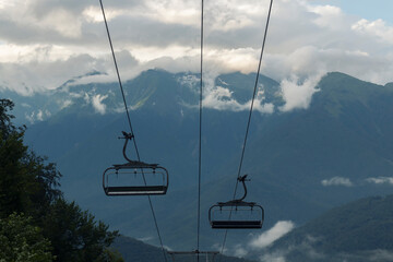 A ski resort in Sochi against the backdrop of nature on a summer day. Cable car with opened cabins...