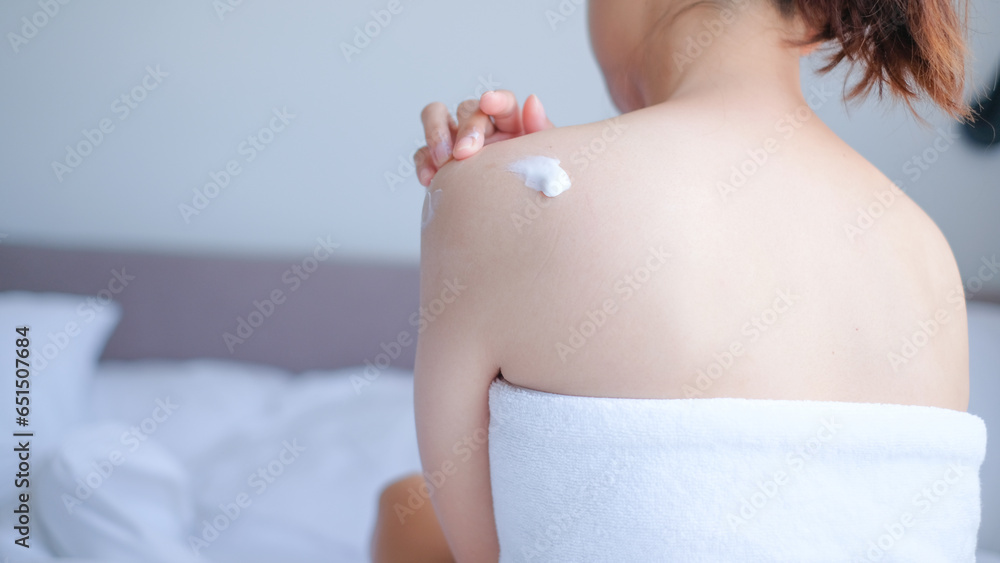 Wall mural Woman applying natural cream, Woman moisturizing her back with cosmetic cream, Spa and Manicure concept.