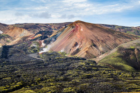 Red Brennisteinsalda Rhyolite Mountain surrounded by black Lava Field, Landmannalaugar, Iceland