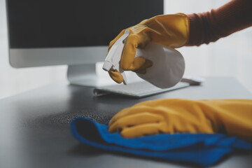 Office Cleaning Service. Janitor Spraying Desk. Workplace Hygiene