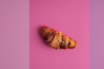 Isolated croissant with chocolate on a pink background. 