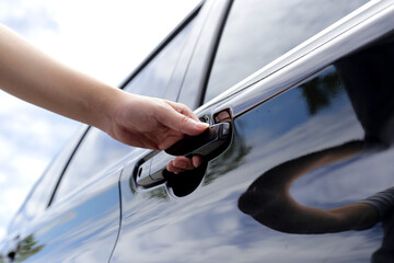 Male hand opening car door